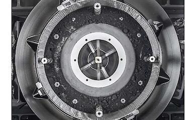 This image provided by NASA shows a top-down view of the OSIRIS-REx Touch-and-Go-Sample-Acquisition-Mechanism (TAGSAM) head with the cover removed, revealing the remnants of an asteroid sample inside.