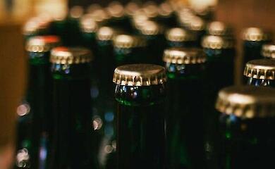 Several dark glass bottles with metal caps