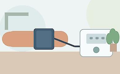 Home automatic blood pressure monitor with cuff on the arm on a table