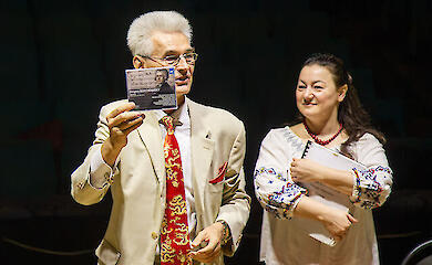 German Makarenko shows off his newly released CD during a rehearsal for a stage production of the opera *Creon*, Kyiv, August 2026