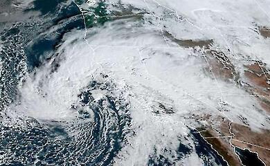 Satellite view of a band of clouds over the Pacific Ocean and the western coast of North America.